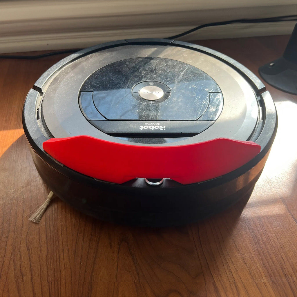 Bumper extension strip on the front bumper of a Roomba robot vacuum