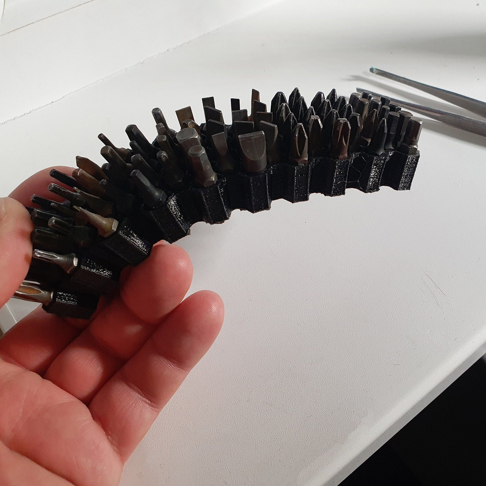 a person is holding a bunch of screws in their hand