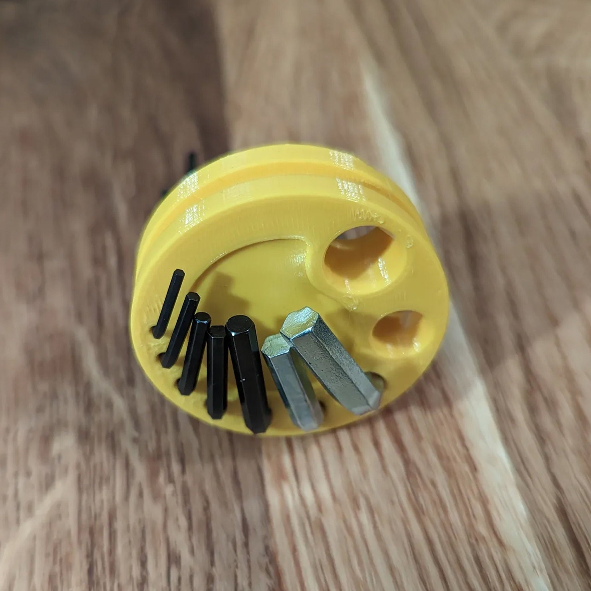 a yellow brush with a bunch of screws in it