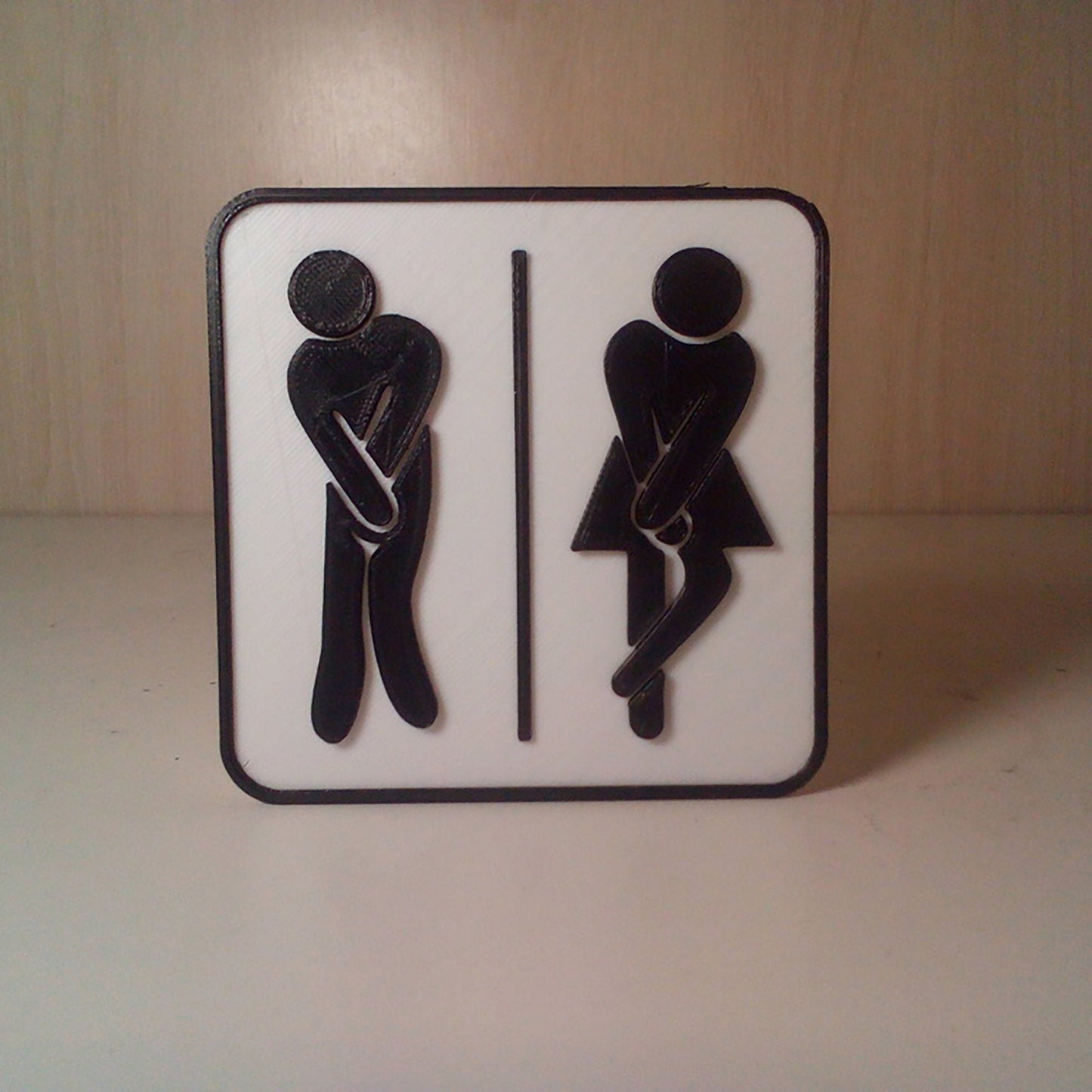 a white and black sign with a man and a woman on it