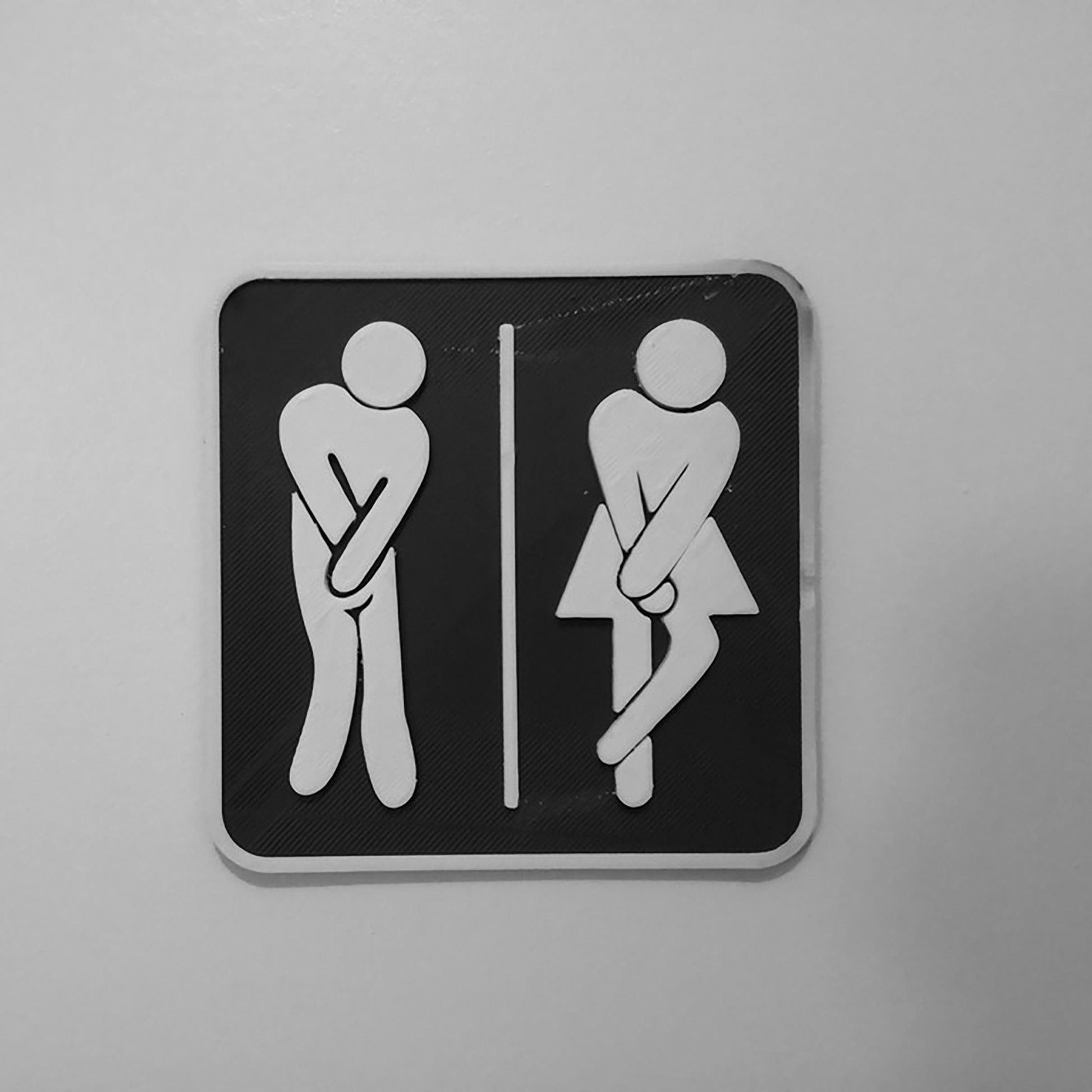 a black and white picture of a toilet sign