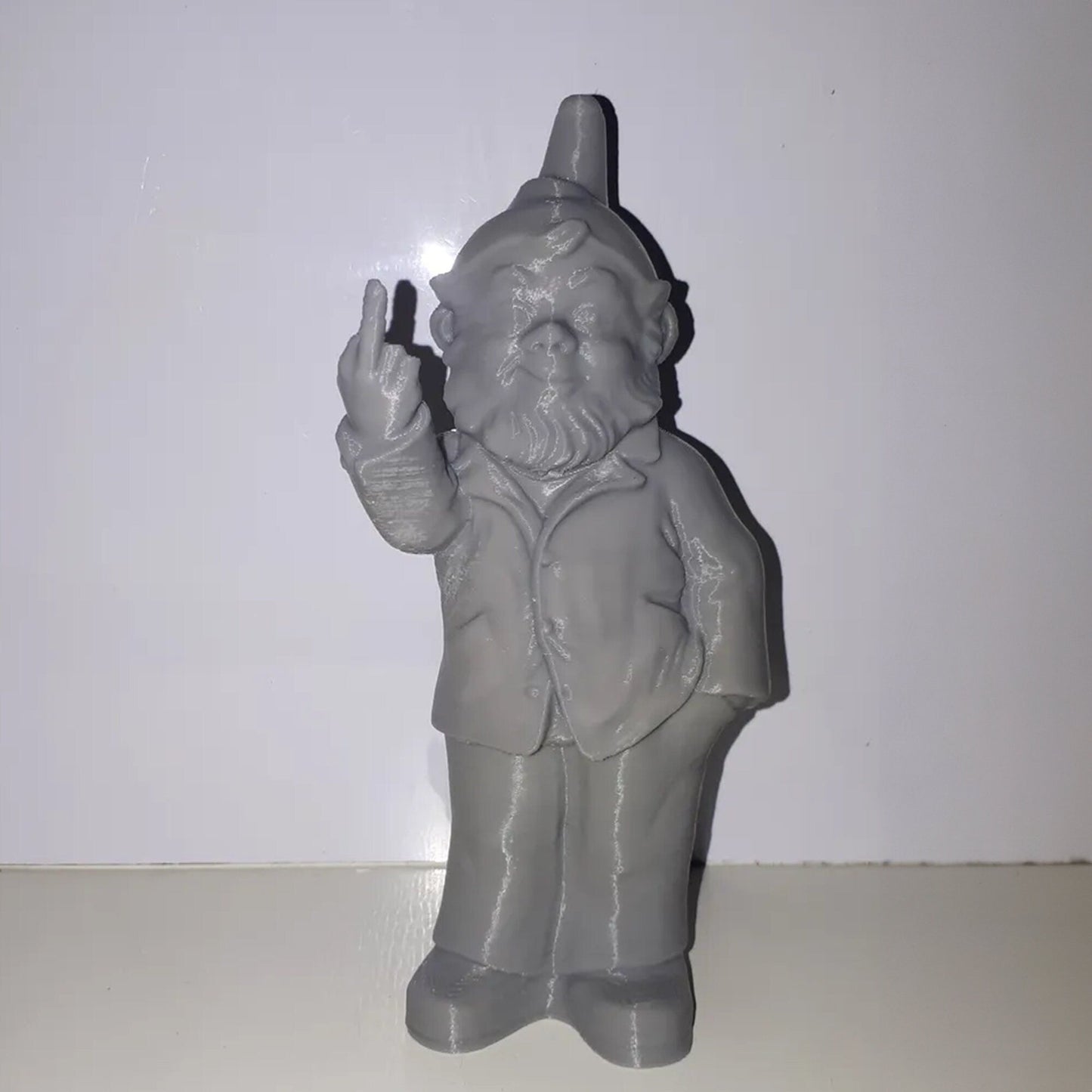 a plastic statue of a man holding a cigarette