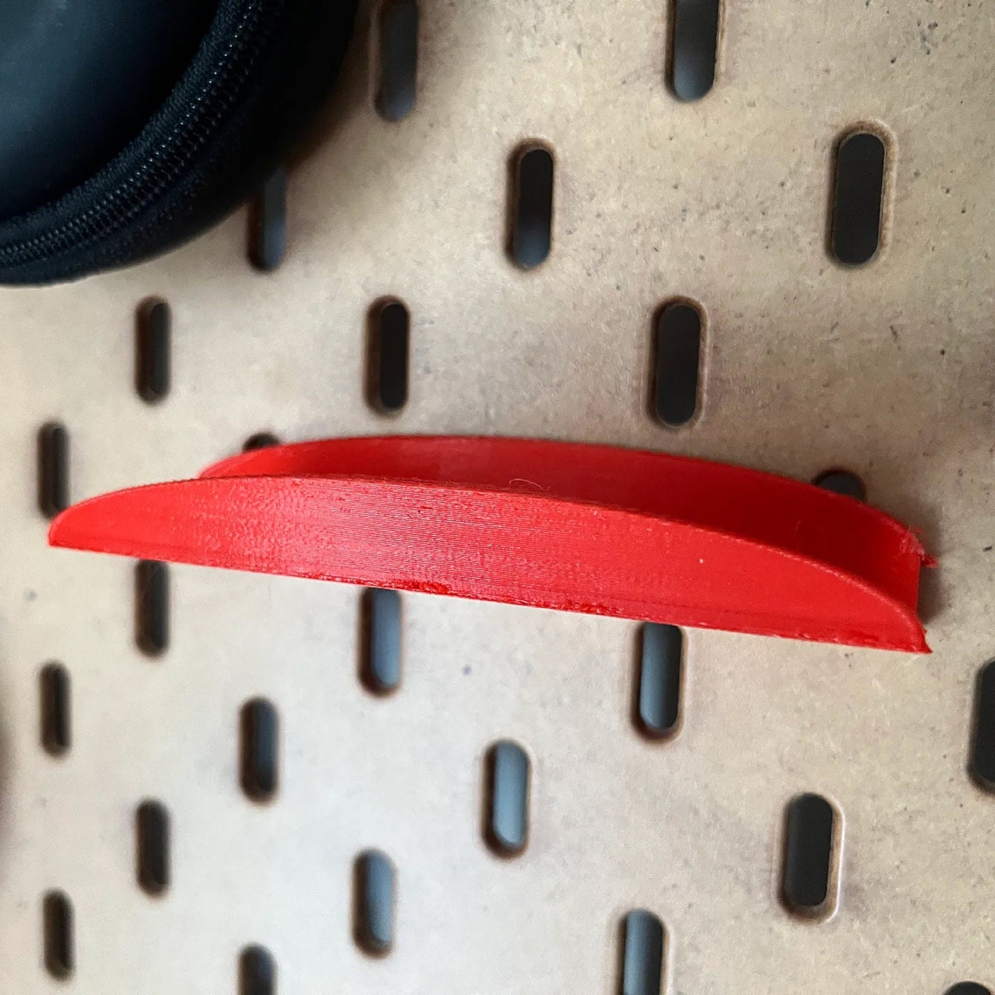 a red piece of paper sitting on top of a metal shelf