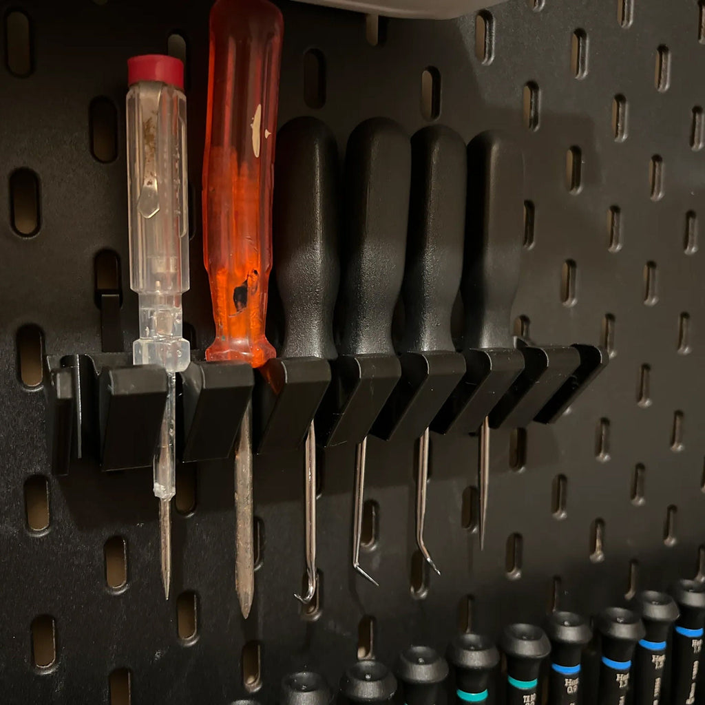 Screwdriver holder for IKEA SKADIS pegboard with angled slots holding drivers handle up, view 6