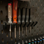Screwdriver holder for IKEA SKADIS pegboard with angled slots holding drivers handle up, view 6