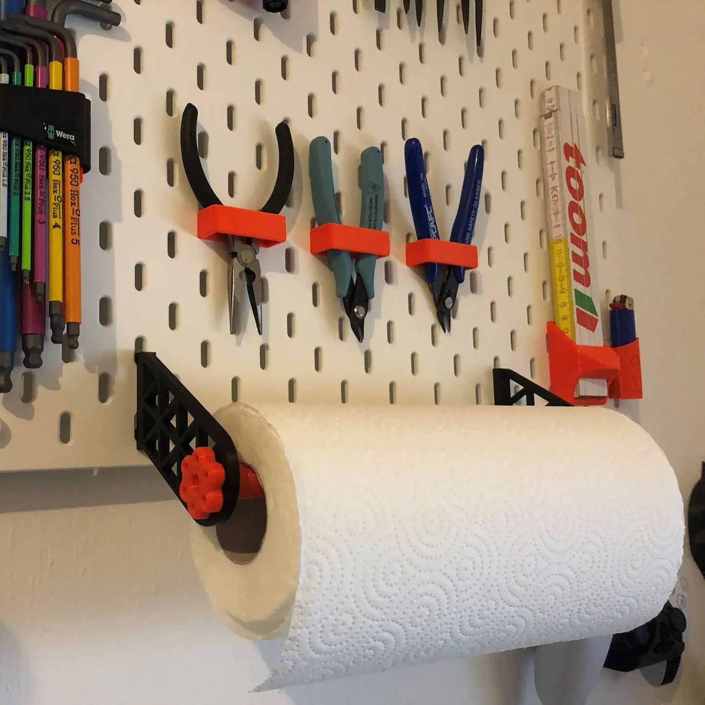 a white pegboard with a bunch of tools on it