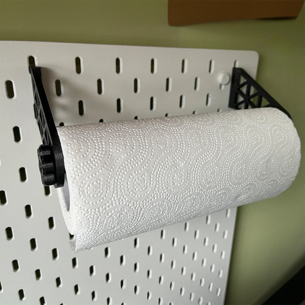 Paper towel holder for IKEA SKADIS pegboard with a kitchen roll on a rotating end cap