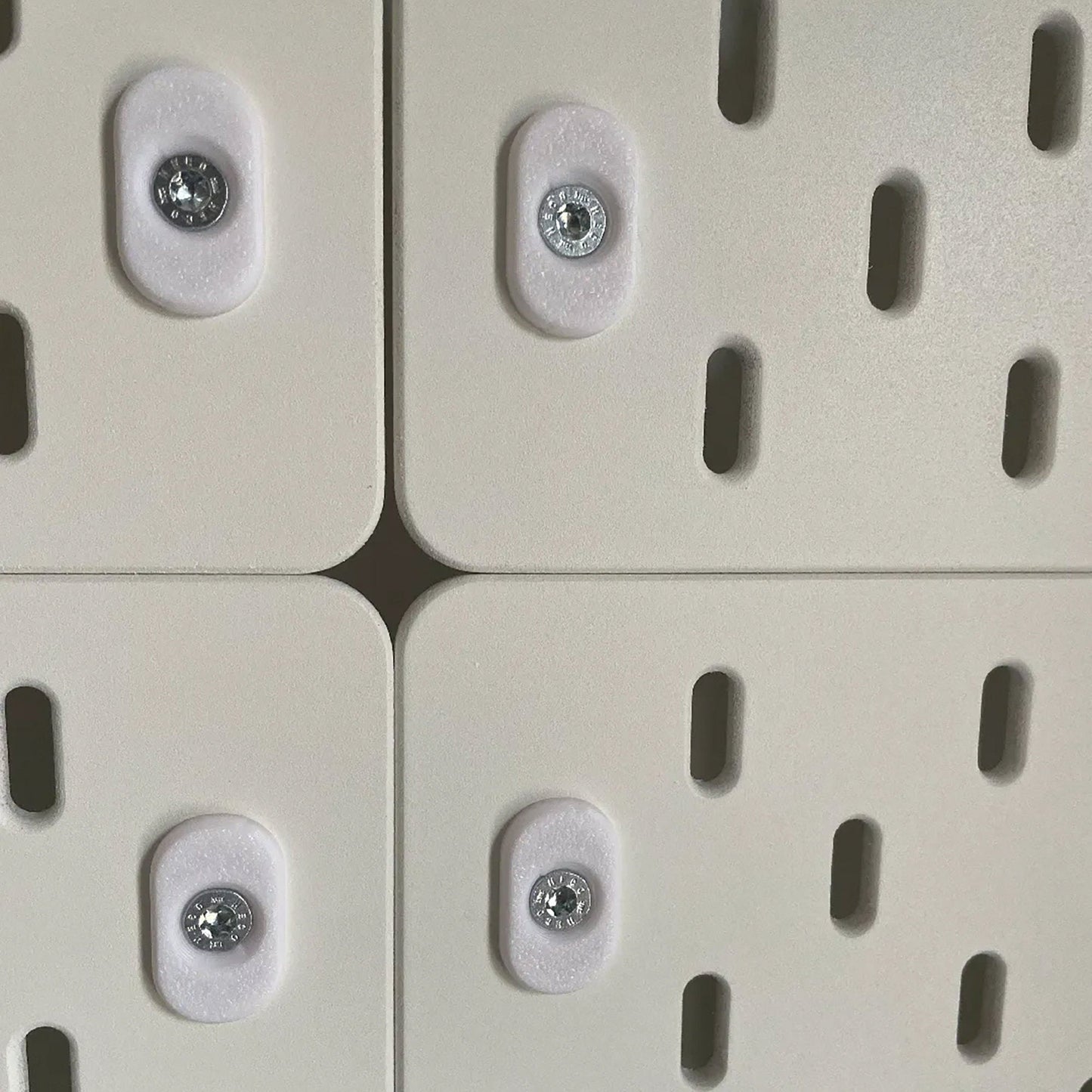 a close up of four white buttons on a wall