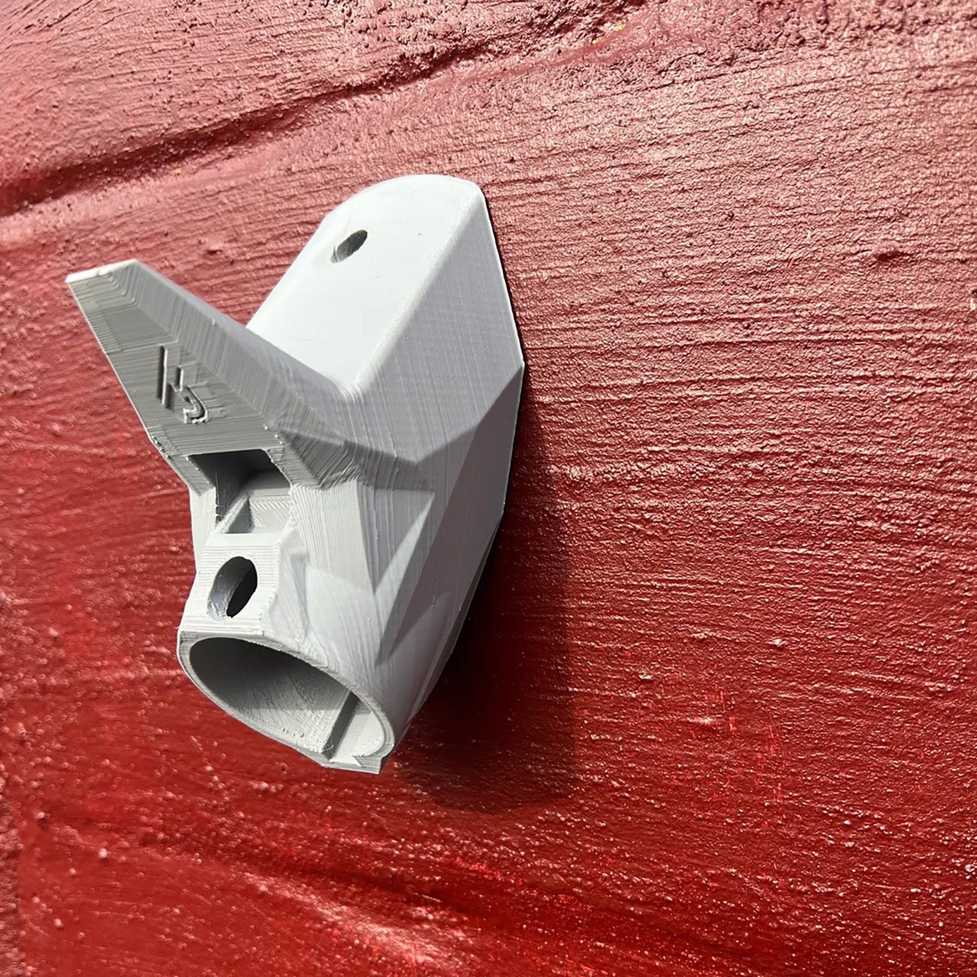 a close up of a light switch on a red wall