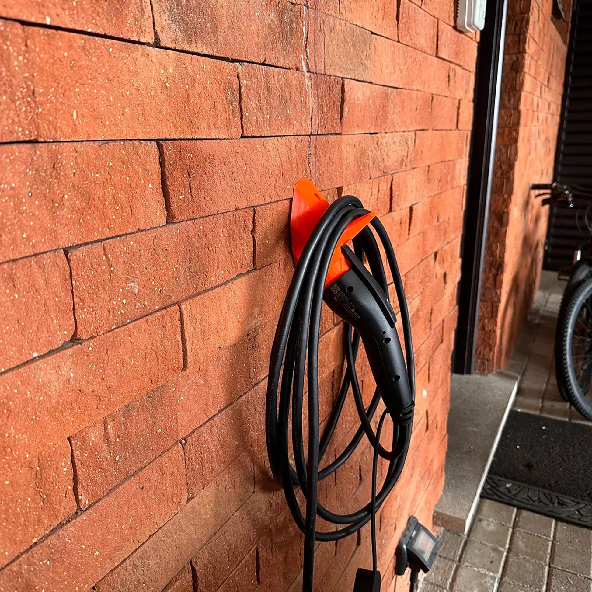 a red brick wall with a charger attached to it