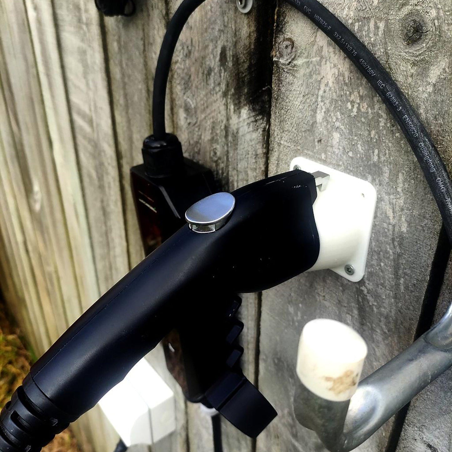 a bicycle handlebar attached to a wooden fence