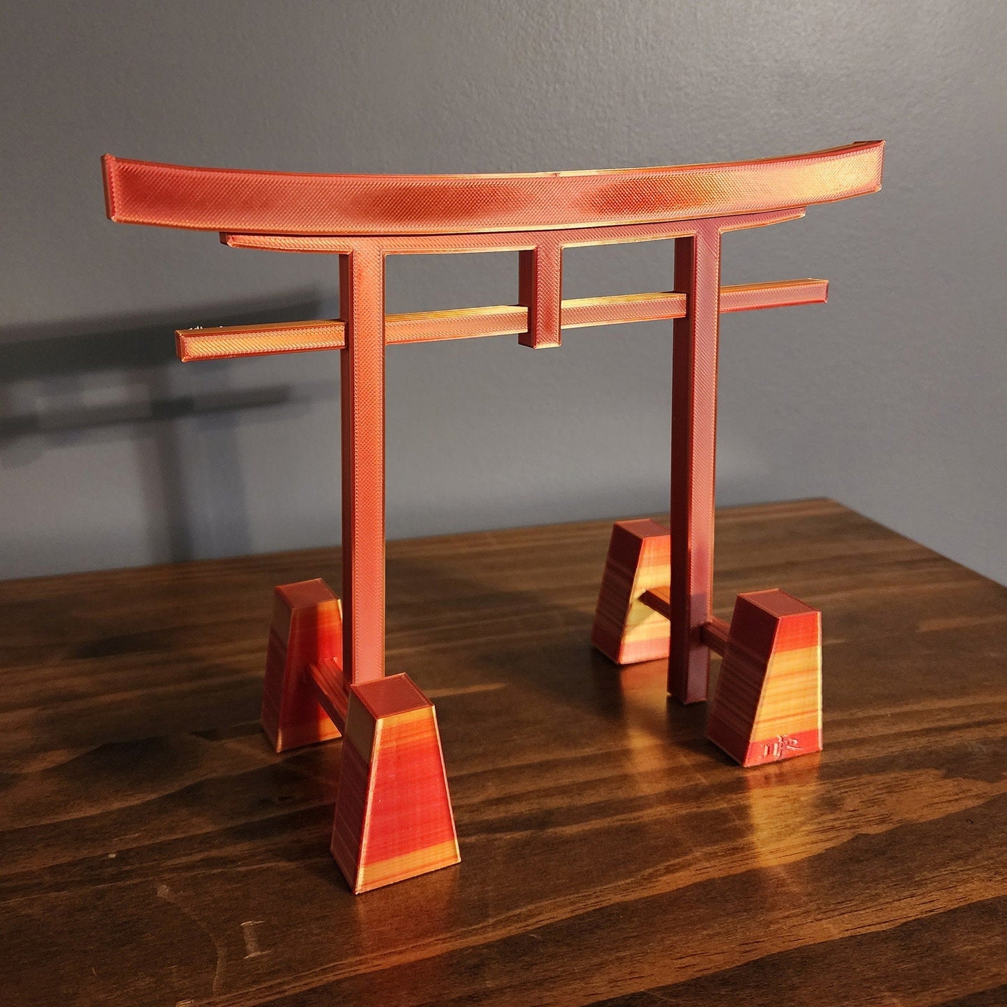 a wooden table topped with a red and orange object