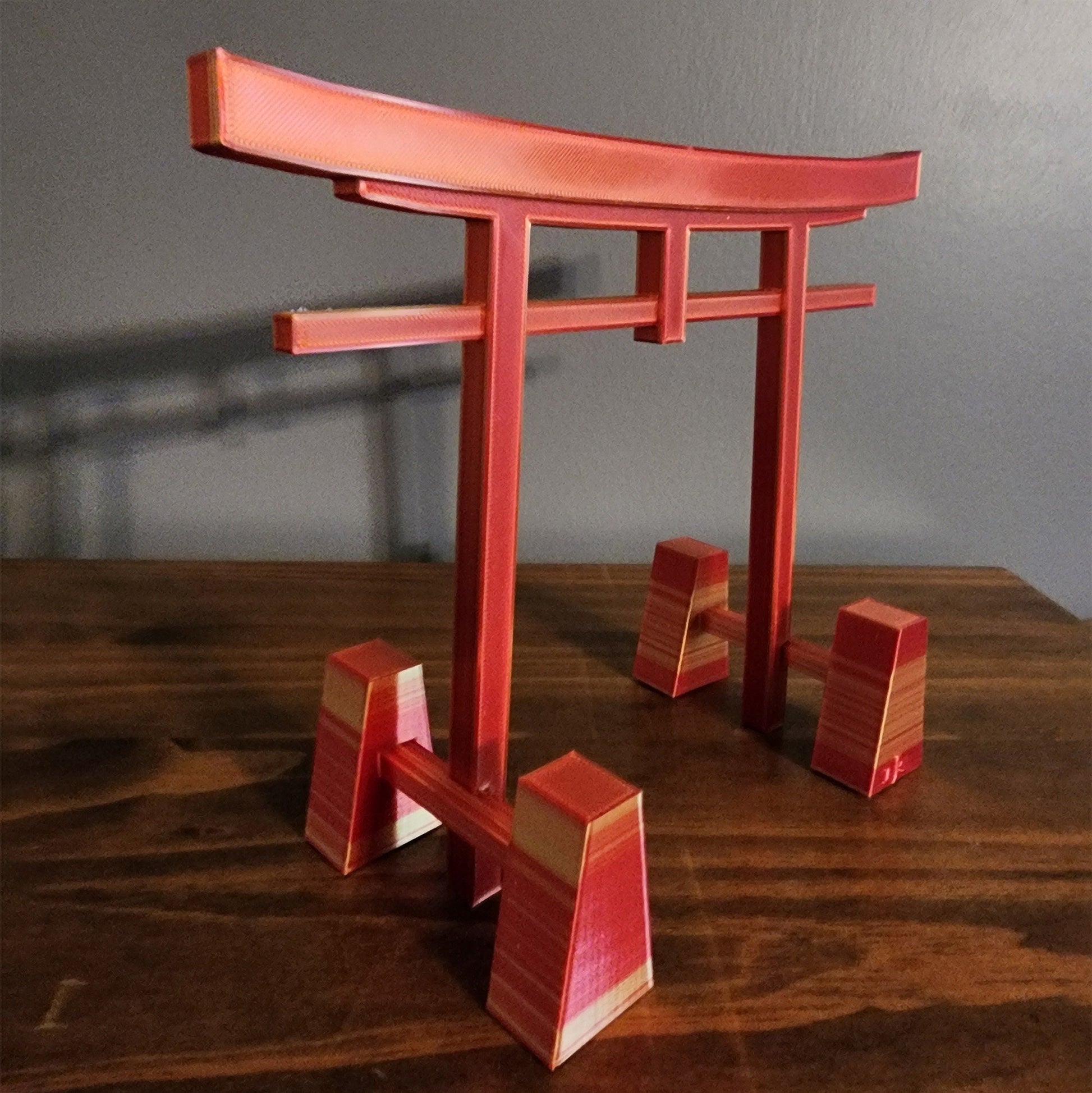 a wooden table topped with a red wooden table