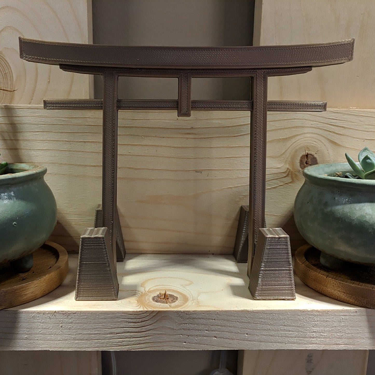 a couple of pots sitting on top of a wooden shelf