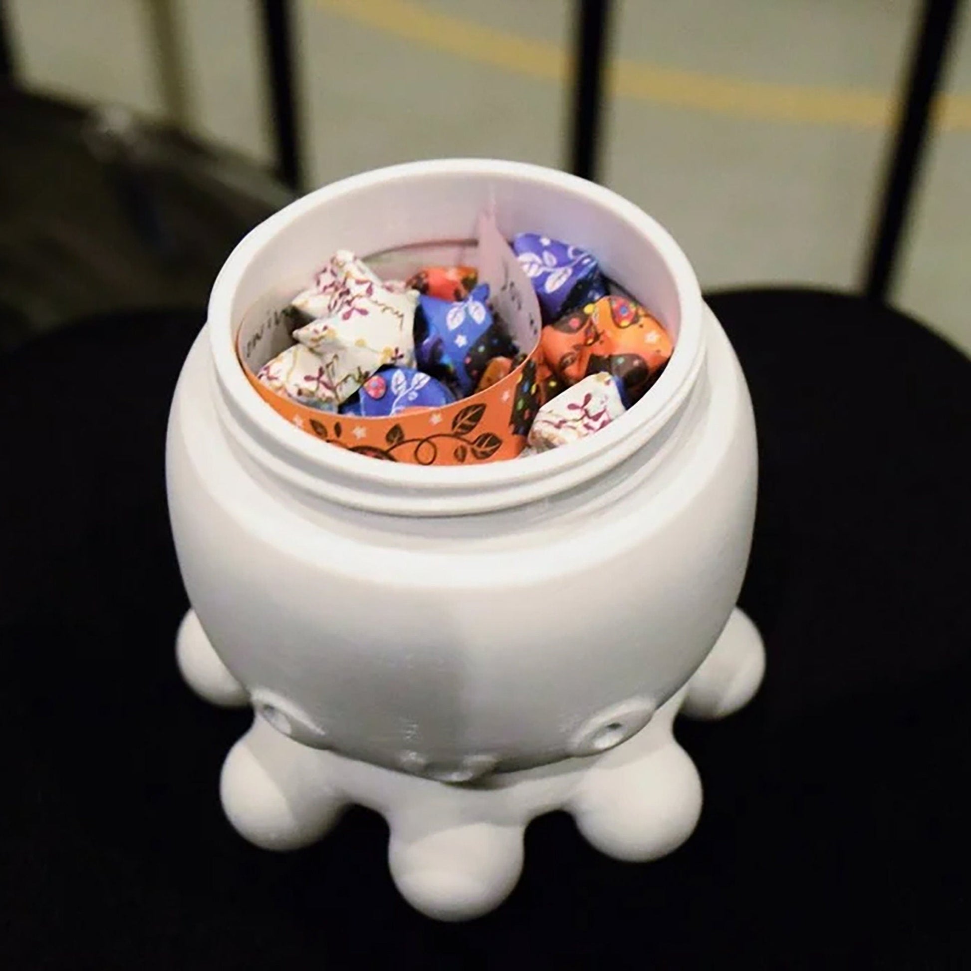 a white container filled with candy sitting on top of a table