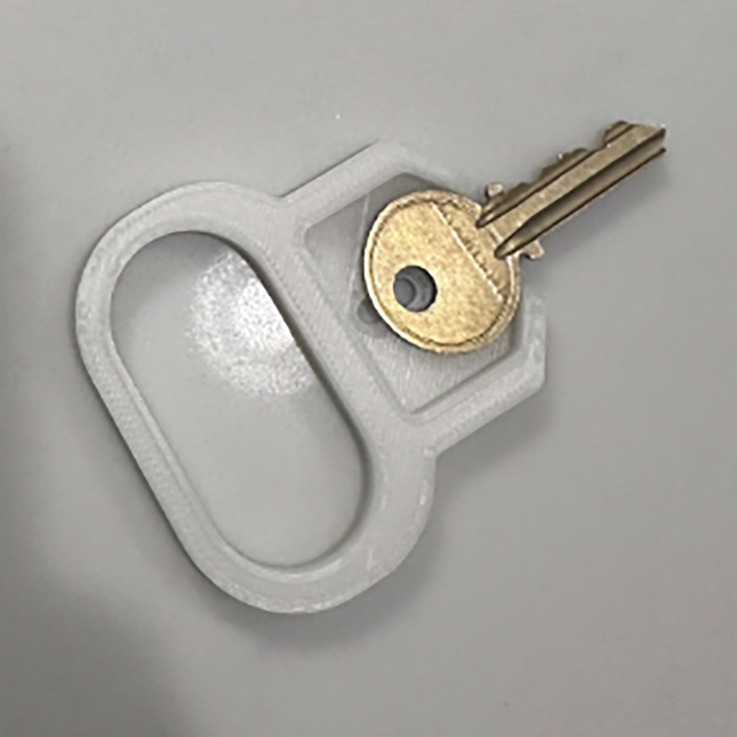 a pair of keys sitting on top of a key holder