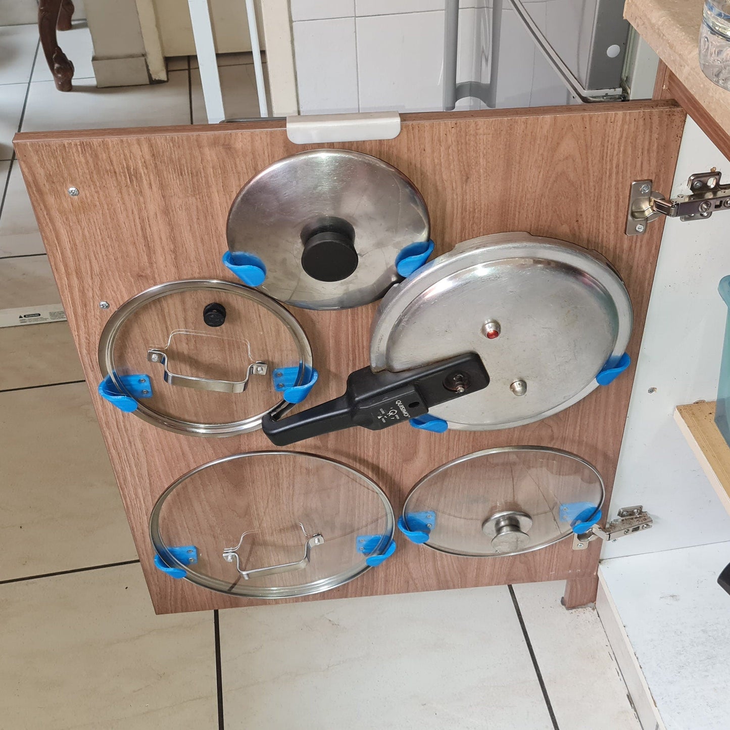 a set of pots and pans in a cabinet