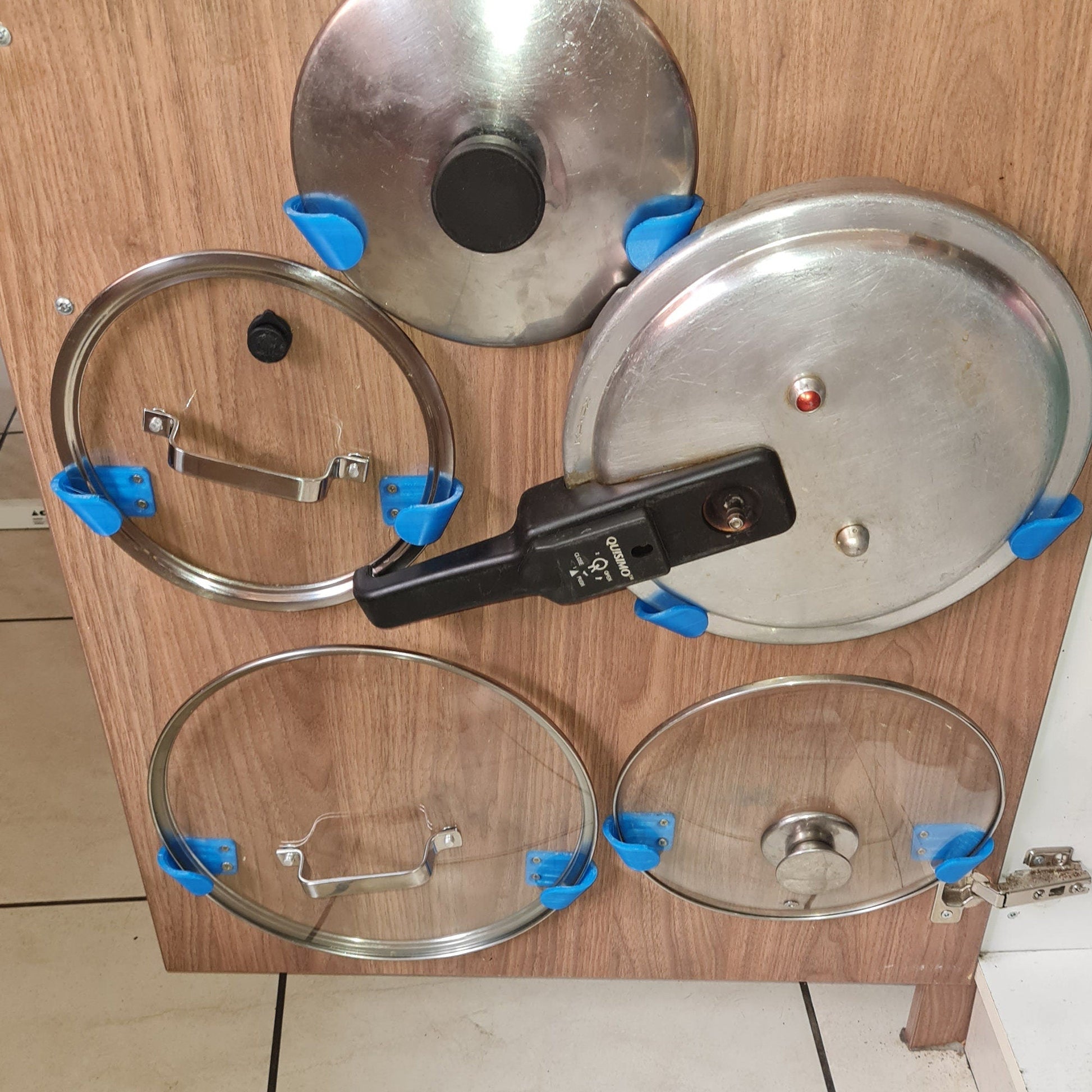 a set of pots and pans sitting on top of a wooden cabinet