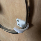 Pair of angled brackets holding a glass pot lid on a kitchen cabinet door, view 5