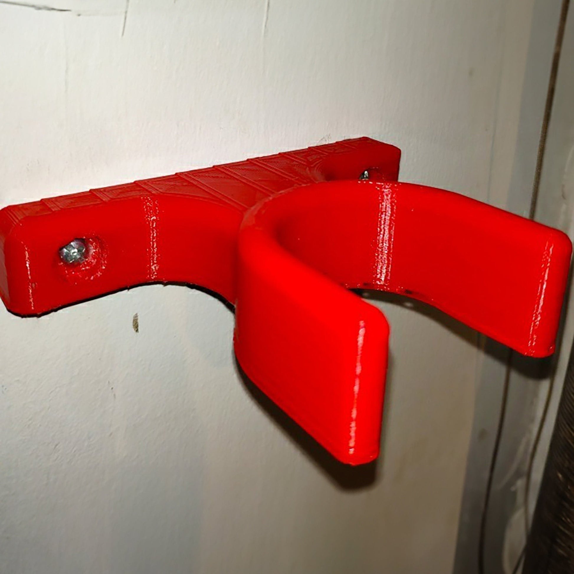 a close up of a red object on a wall