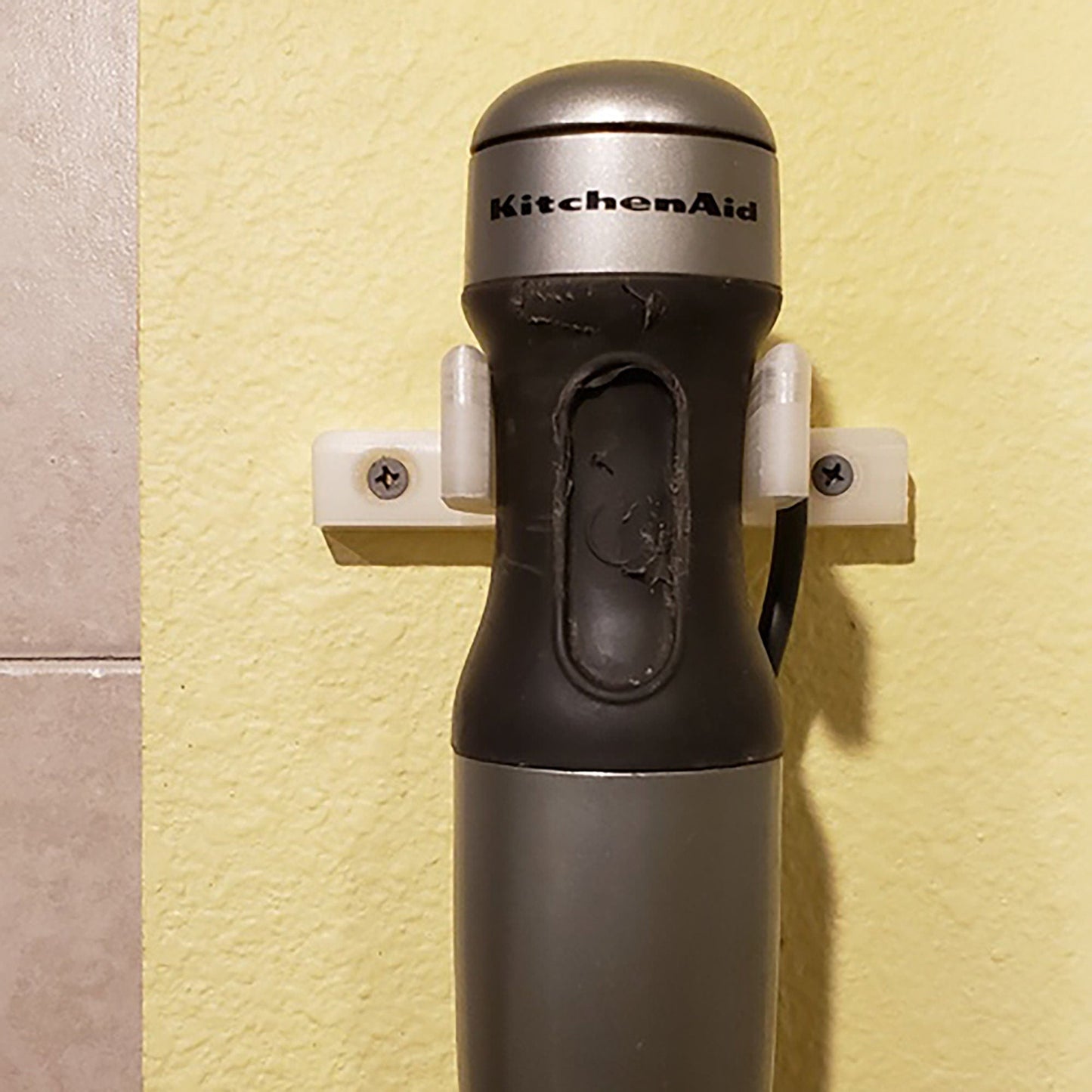 a kitchen aid bottle mounted to a wall