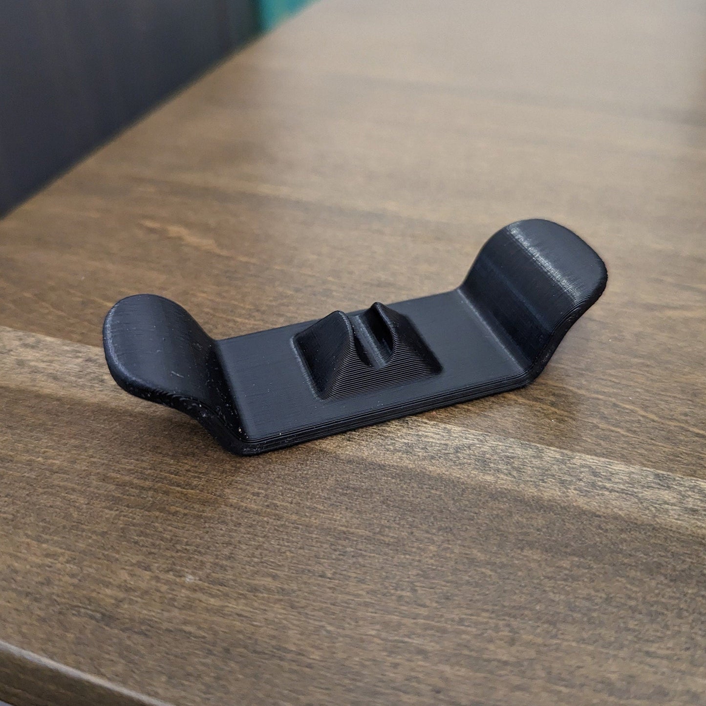 a black object sitting on top of a wooden table