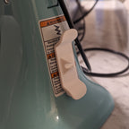 Adhesive twin-prong cord cleat on the back of a KitchenAid stand mixer, view 5
