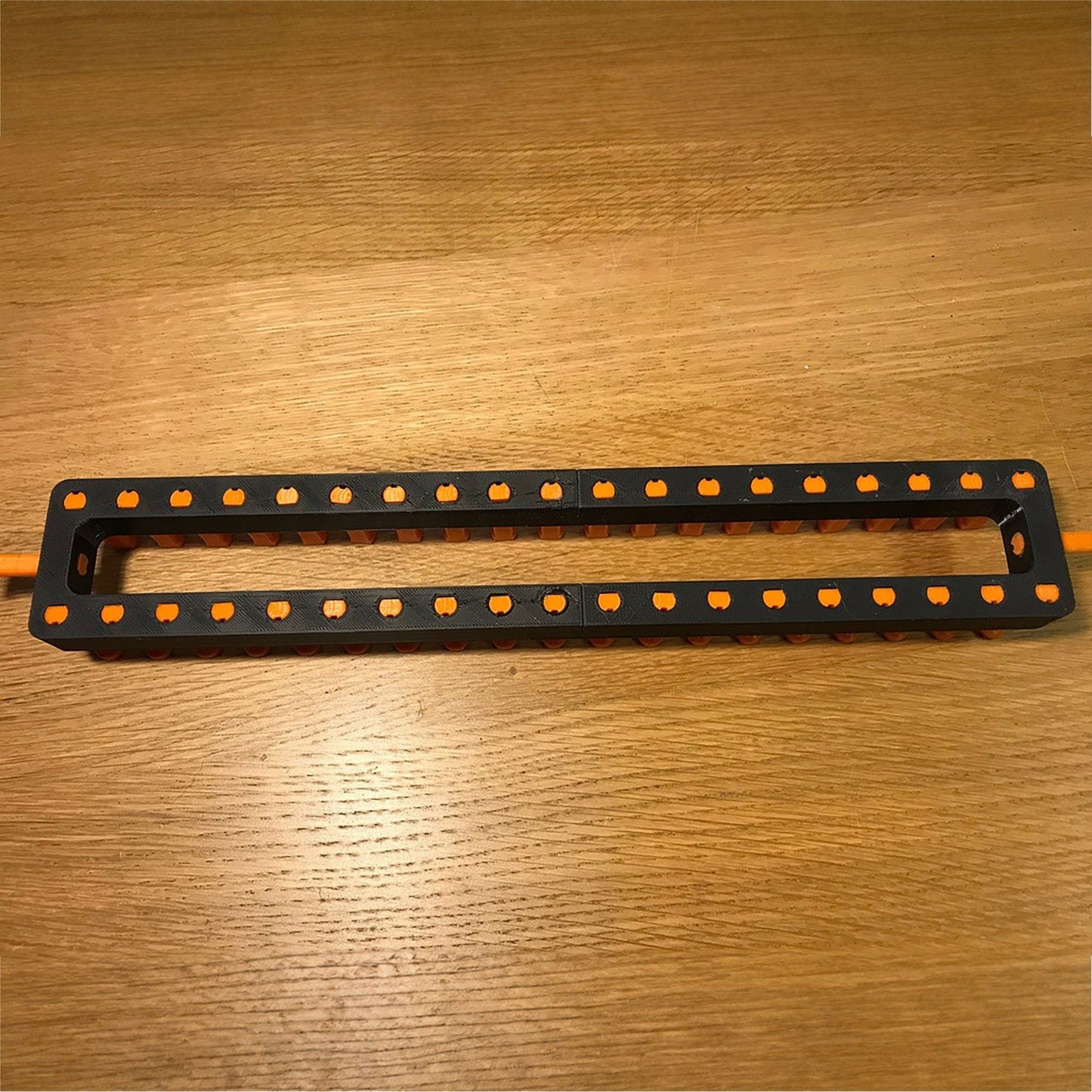 a pair of black and orange handles on a wooden table