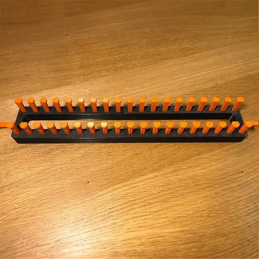 a pair of orange and black toothbrushes on a wooden table