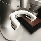 Dosing cup holder adapter mounted under the spout of a Lagom P64 grinder, view 2