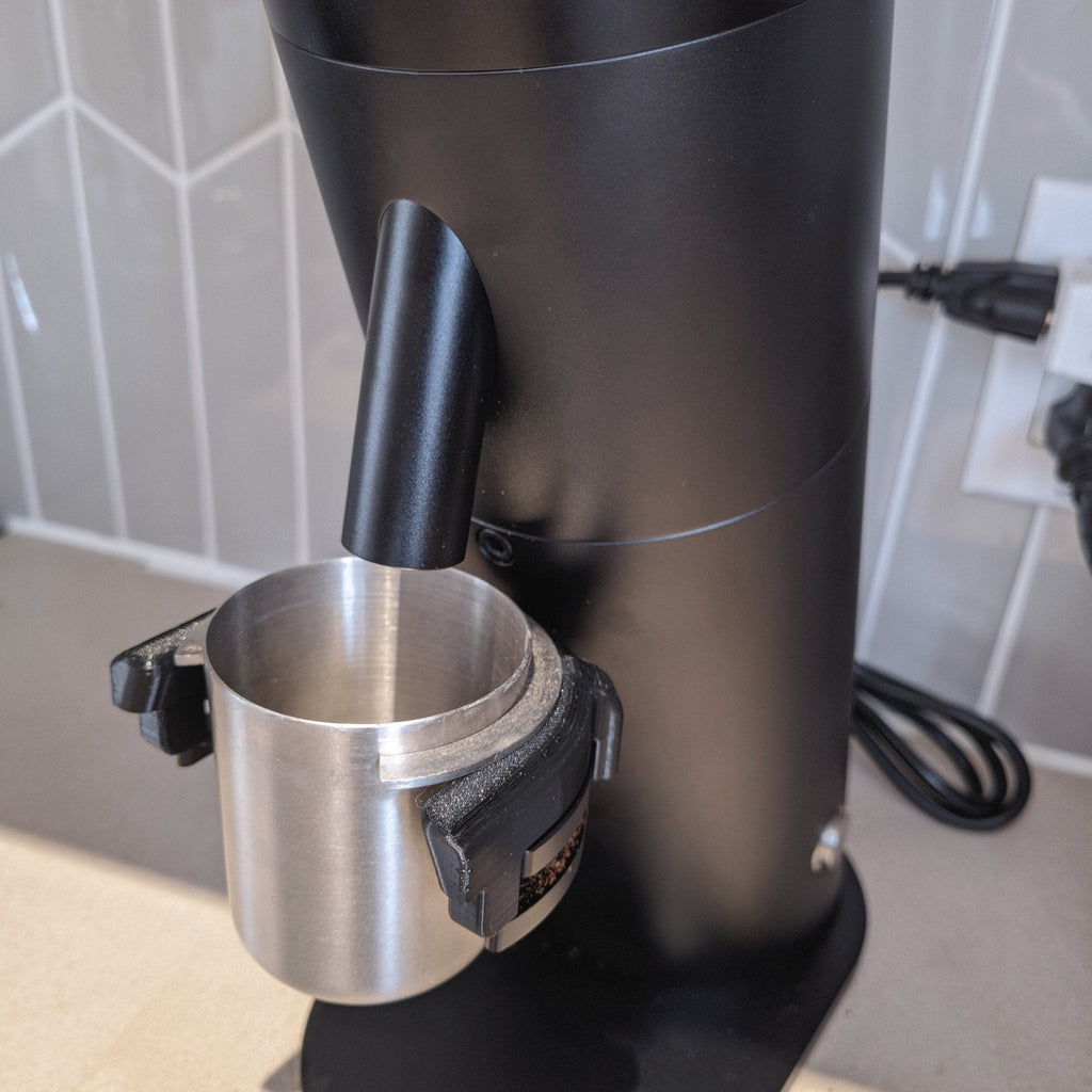 Dosing cup holder adapter mounted under the spout of a Lagom P64 grinder, view 3