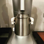 Dosing cup holder adapter mounted under the spout of a Lagom P64 grinder, view 4