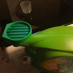 Detergent cup drip catcher on a Tide laundry bottle spout holding the measuring cup, view 7