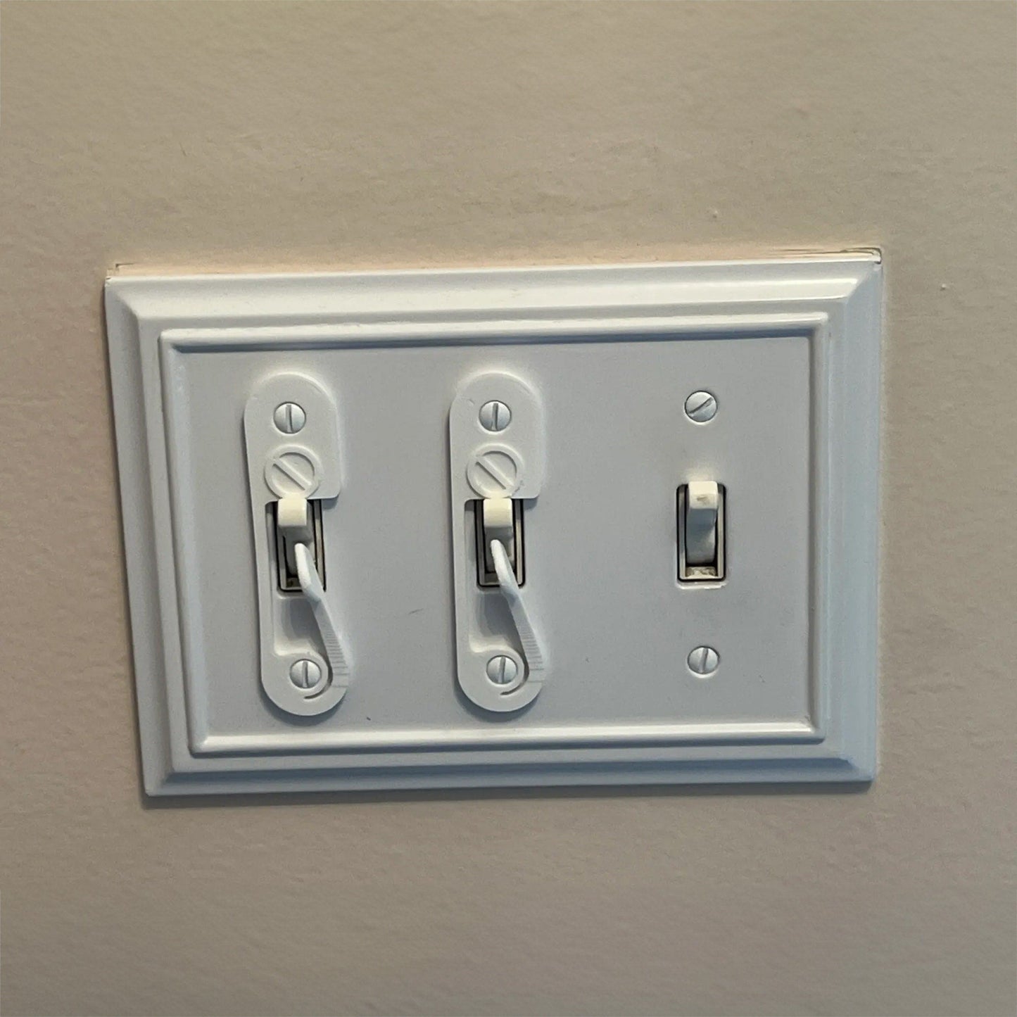 a close up of a light switch on a wall