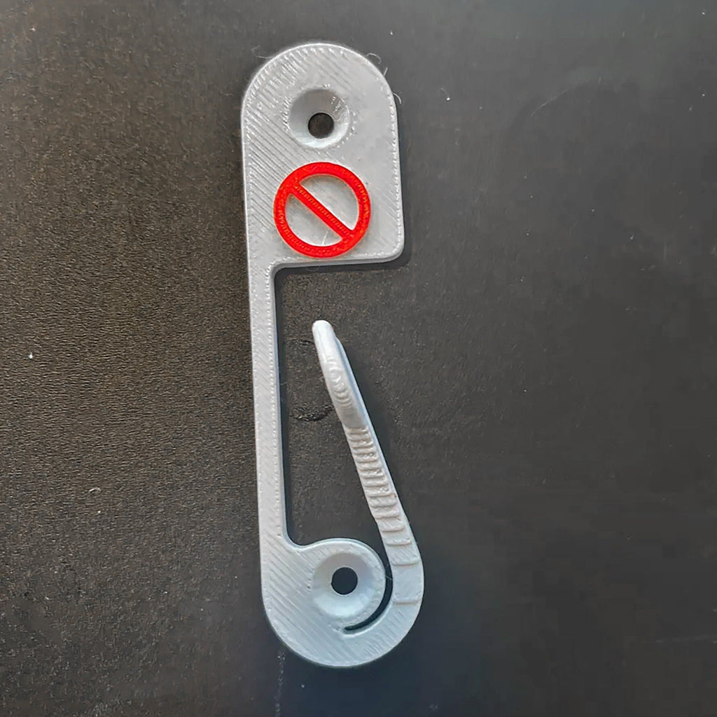Light switch lock with pivoting arm and marked toggle cap on a wall switch, view 3