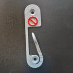 Light switch lock with pivoting arm and marked toggle cap on a wall switch, view 3