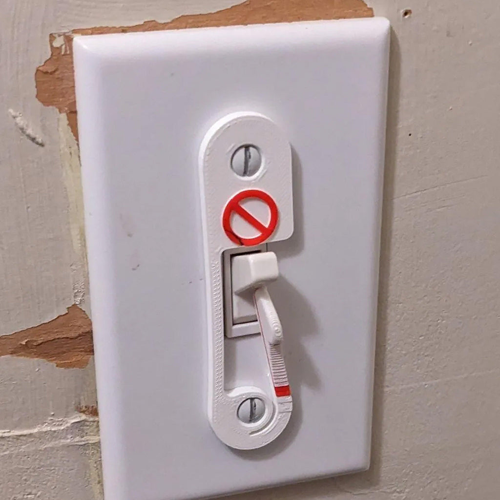 Light switch lock with pivoting arm and marked toggle cap on a wall switch, view 4