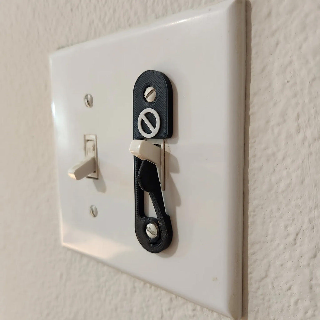 Light switch lock with pivoting arm and marked toggle cap on a wall switch, view 5