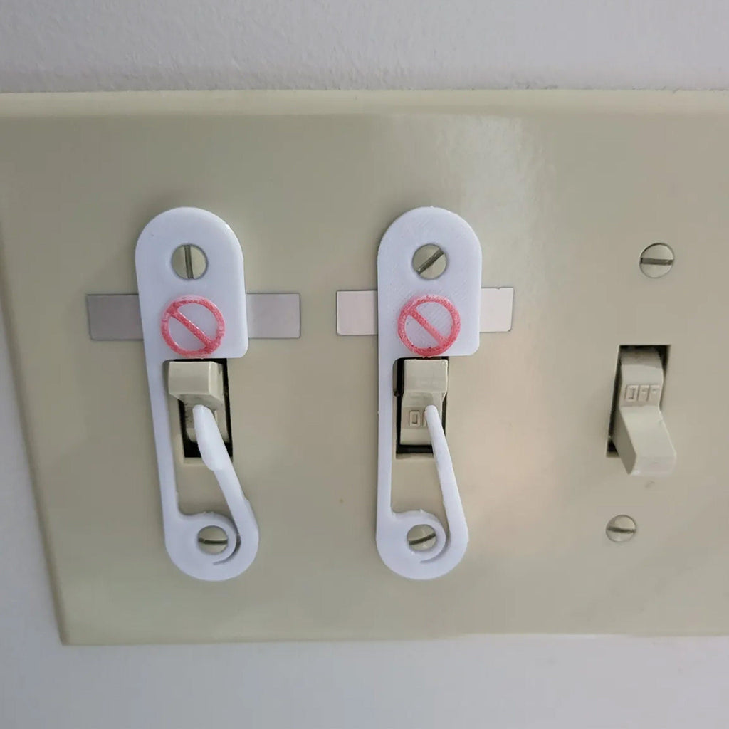 Light switch lock with pivoting arm and marked toggle cap on a wall switch