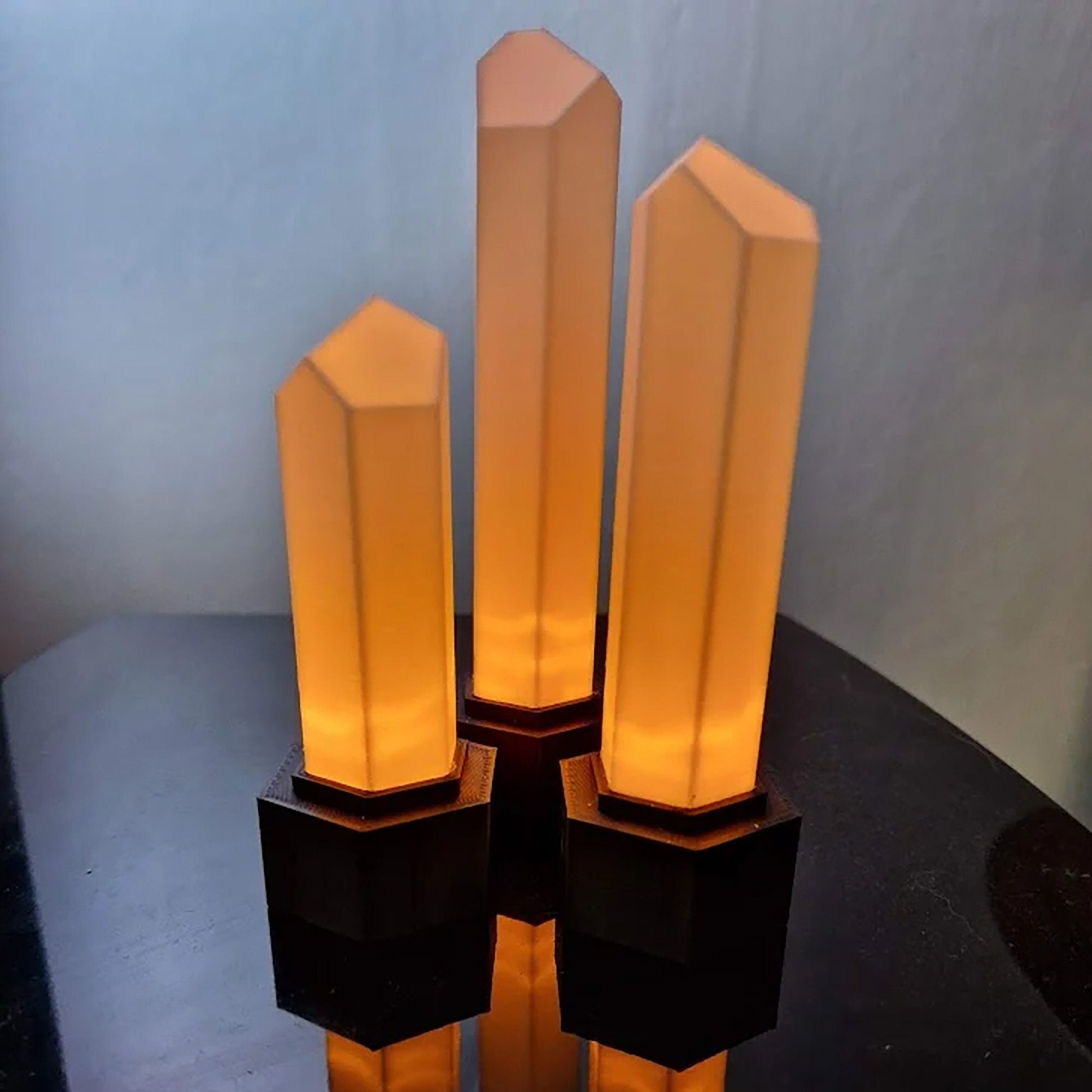 a group of three candles sitting on top of a table