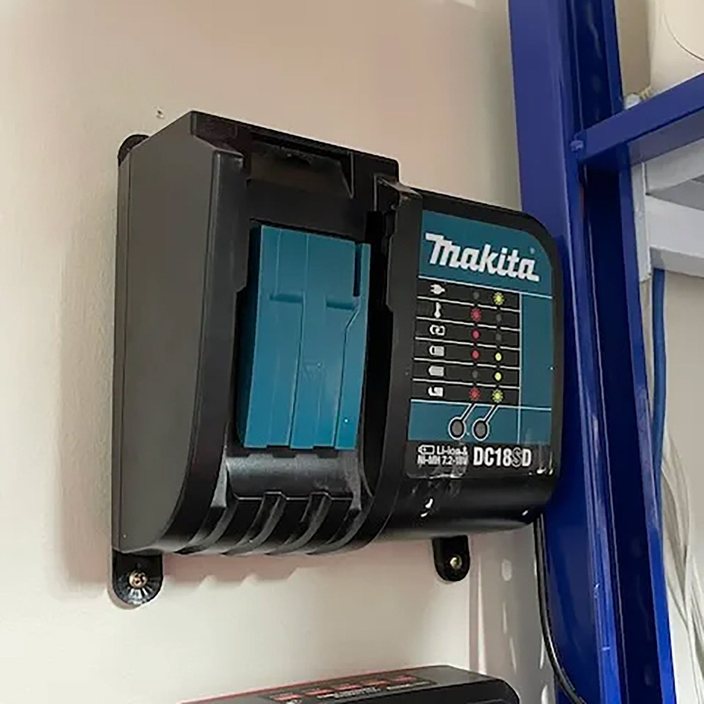 a blue and black device mounted to a wall