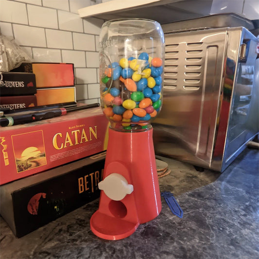 a gummy machine sitting on top of a counter