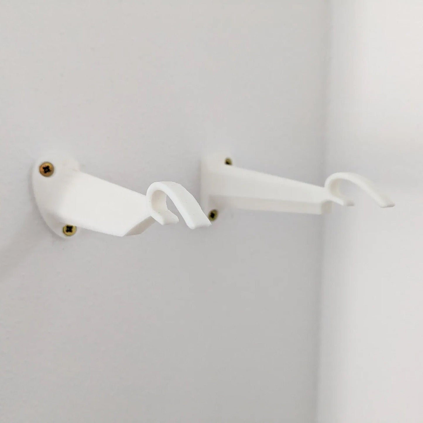 a pair of white handles on a white wall