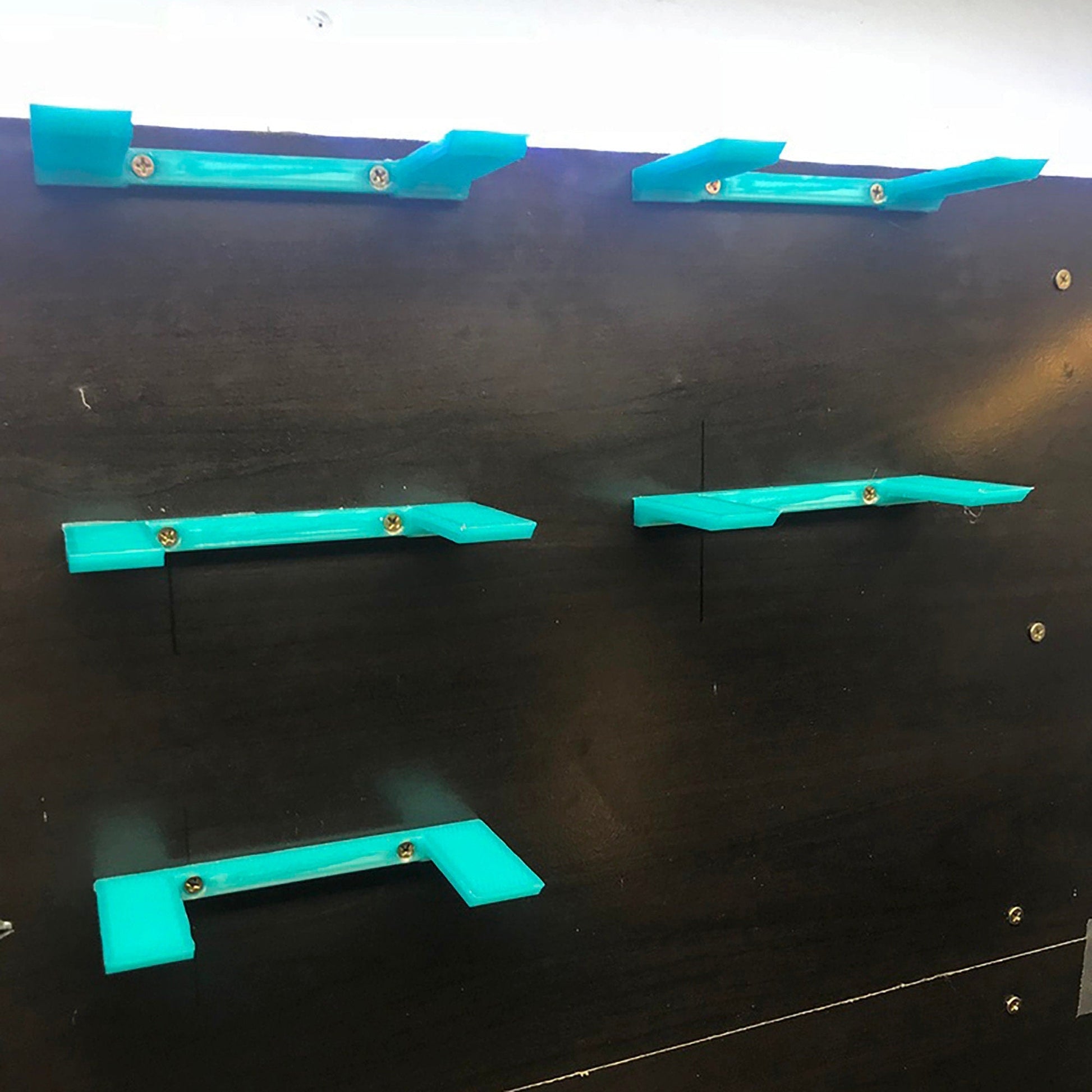 a group of blue shelves on a black wall