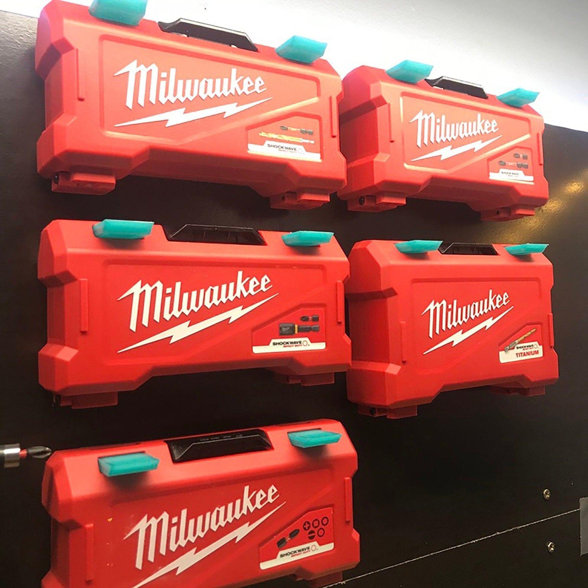 a group of milwaukee tool boxes hanging on a wall