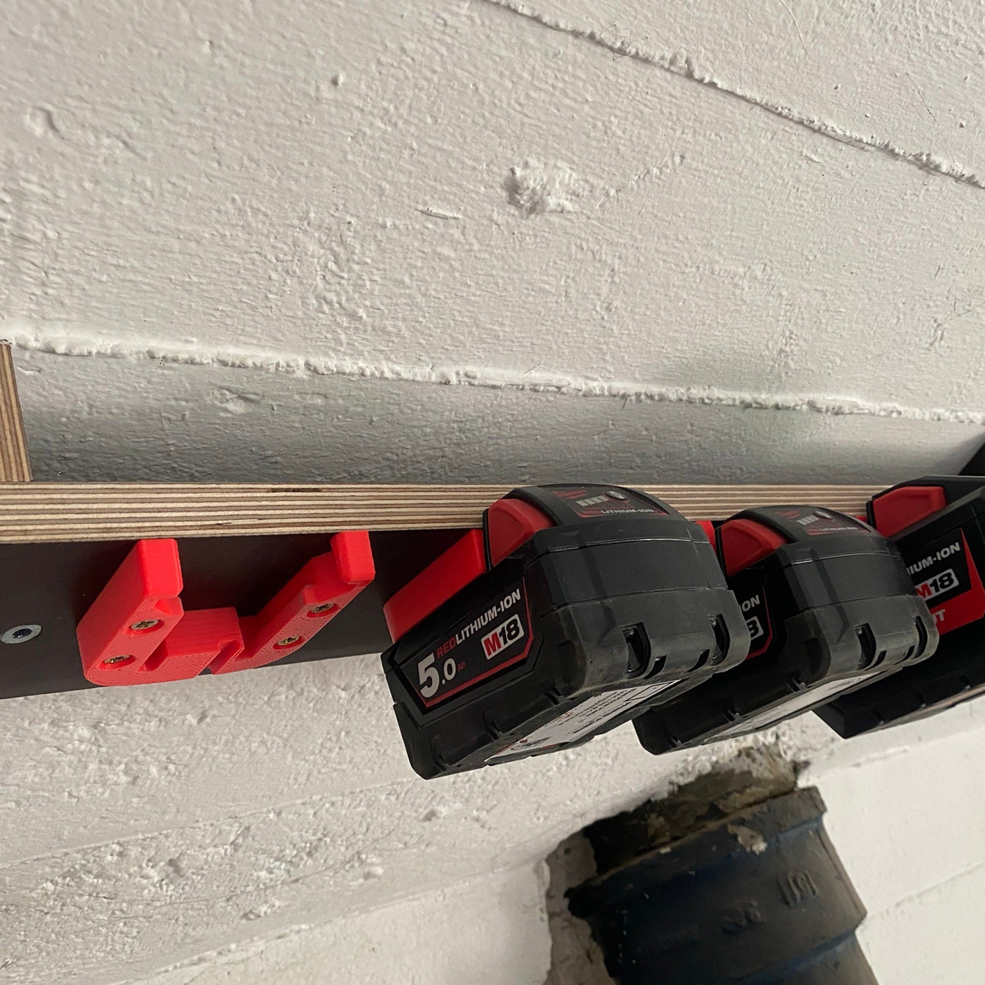 a couple of red and black batteries on a wall