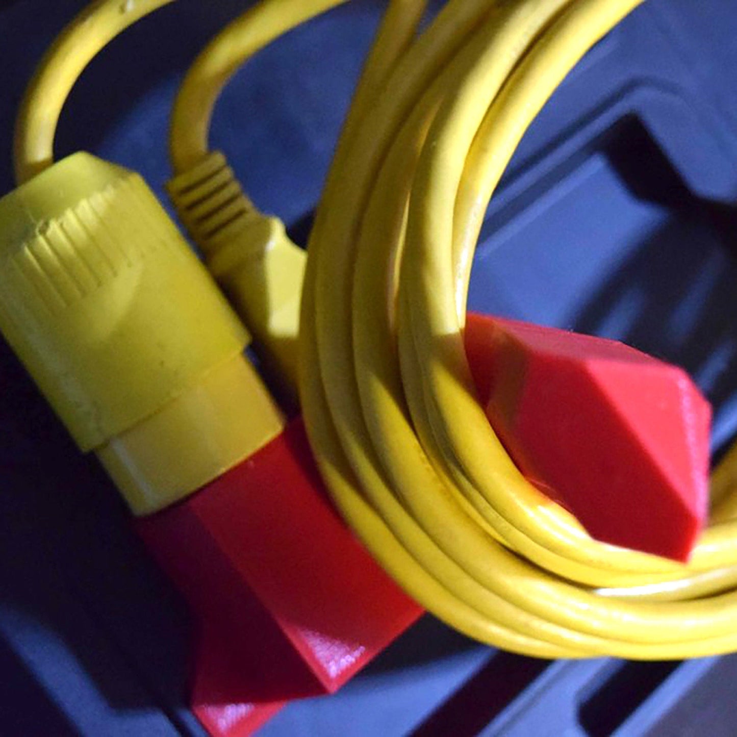 a close up of a yellow and red extension cord