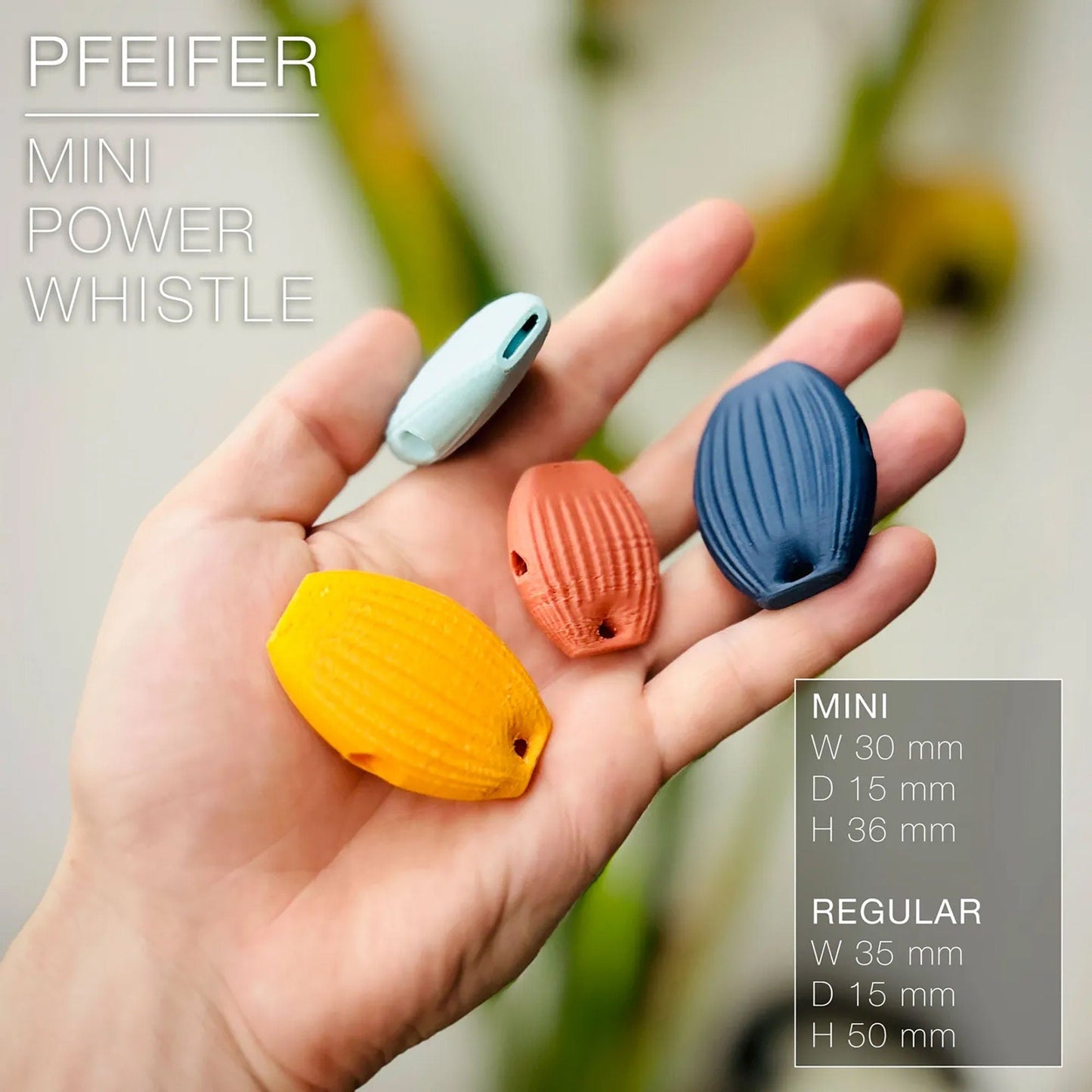 a person holding three small plastic objects in their hand