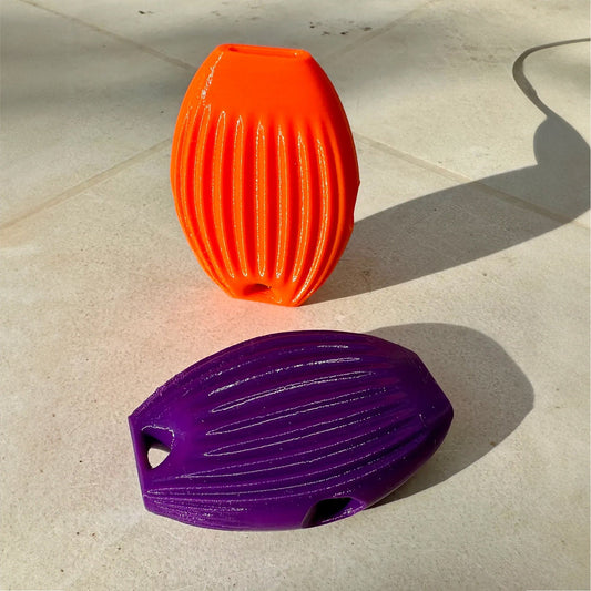 an orange and a purple object sitting on the ground