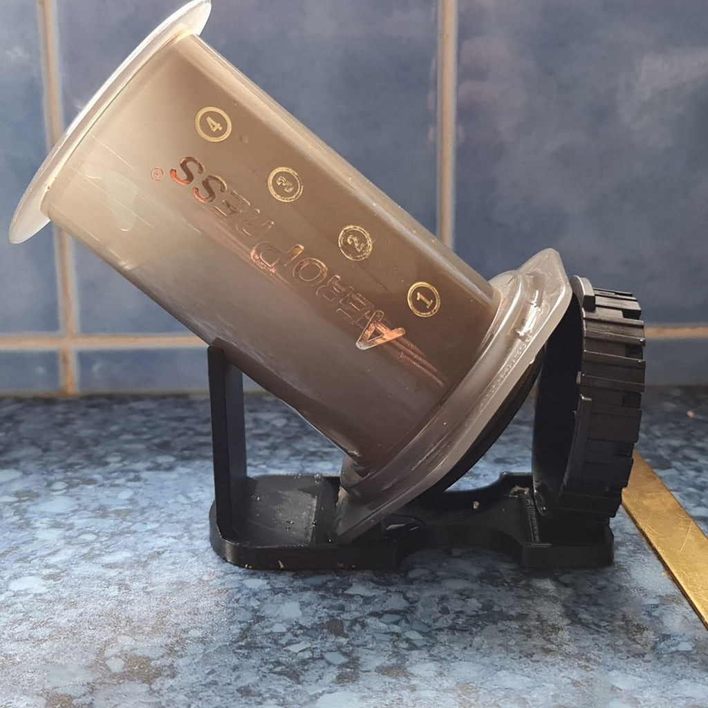 Drip drying stand holding an AeroPress coffee maker upside down